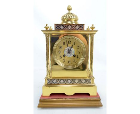 A late 19th century French gilt brass and champlevé enamel detailed mantel clock with gadrooned top above circular dial set w