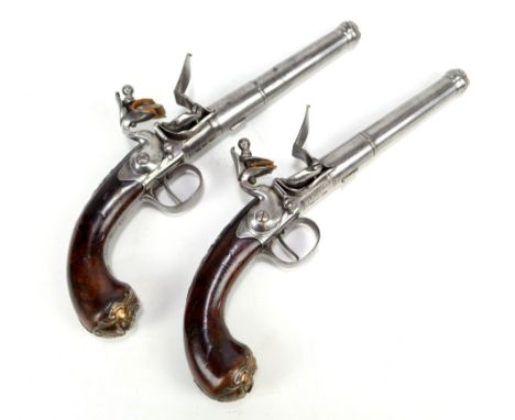 A good pair of early 18th century walnut stocked cannon barrel pistols by Freeman of London, the carved figured walnut stocks