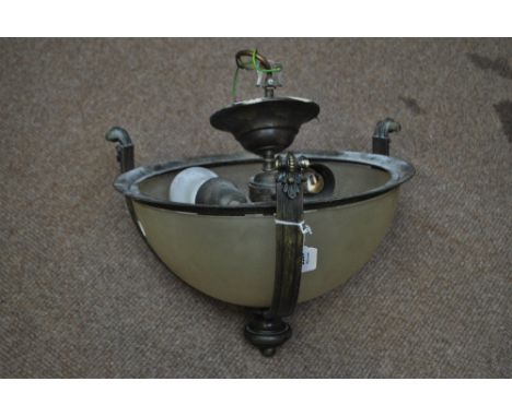 An Arts and Crafts-style brass and frosted glass ceiling light with three square sectioned scrolling supports and turned cent