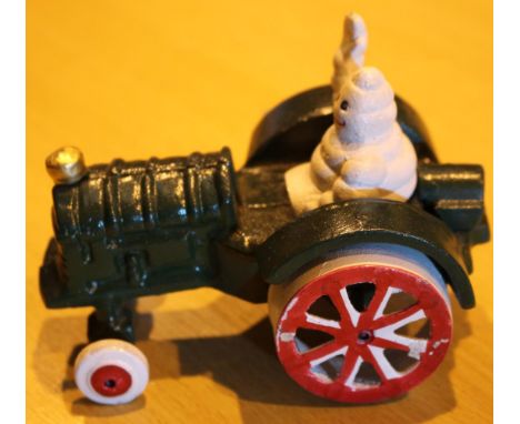 Cast iron Michelin Man in tractor, L: 11 cm. P&amp;P Group 2 (£18+VAT for the first lot and £3+VAT for subsequent lots) 