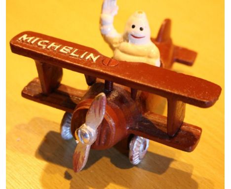 Cast iron Michelin Man in plane, L: 12 cm. P&amp;P Group 2 (£18+VAT for the first lot and £3+VAT for subsequent lots) 