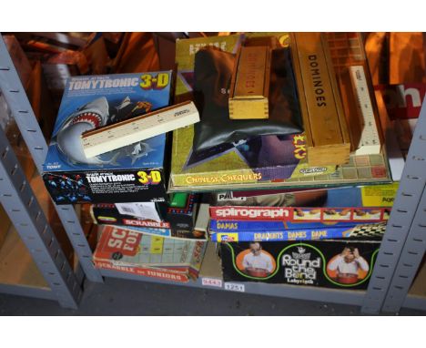 Shelf of mixed puzzles including Scrabble, Dominoes, Connect 4 (contents unchecked). Not available for in-house P&amp;P, cont