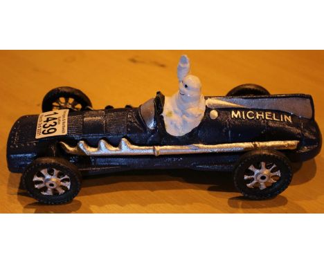 Cast iron blue Michelin Man racer, L: 26 cm. P&amp;P Group 2 (£18+VAT for the first lot and £3+VAT for subsequent lots) 