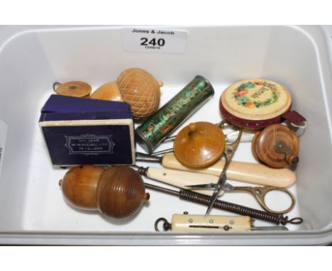 Two vegetable ivory thimble cases, two boxwood cased tape measures, a mother-of-pearl handed awl, a bone cased necessaire set