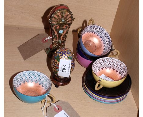 A harlequin set of six Austrian enamelled cabinet cups and saucers, a gilt metal stand set turquoises and a cloisonné decorat
