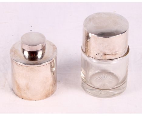 A silver cylindrical tea caddy and a cut glass salts jar with silver lid