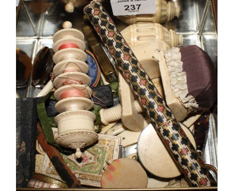 A collection of 19th Century sewing implements including an ivory embroidery thread holder with seven spools, a carved ivory 