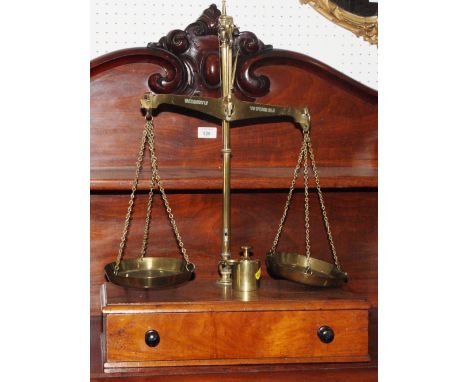 A 19th Century brass balance scale by Avery, on mahogany base fitted one drawer with a selection of brass weights