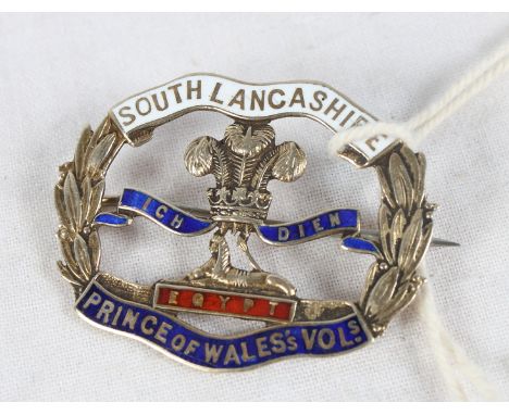 A 9ct gold and enamel decorated badge for the South Lancashire Prince of Wales Volunteers