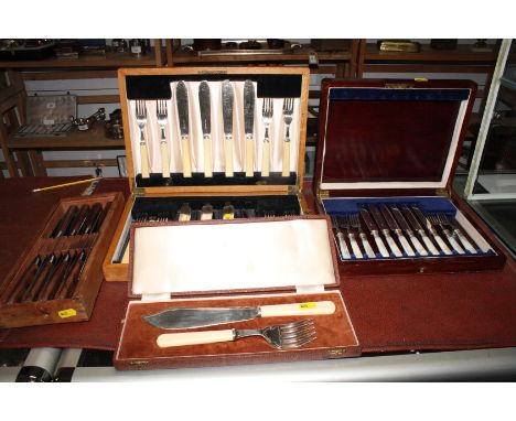 A set of six pairs of mother-of-pearl handled tea knives and forks, in mahogany canteen, a cased set of eight pairs of fish k