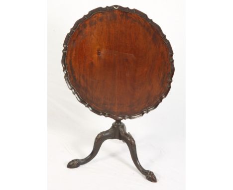 A carved mahogany circular tilt top occasional table with pie crust edge, on carved column and tripod splay supports with pad