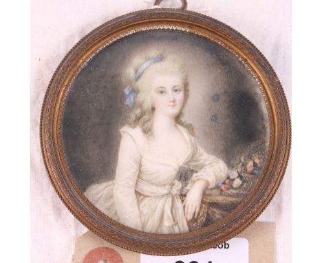 A circular portrait of an unknown lady in 18th Century dress, 3 1/2" dia, in gilt metal frame