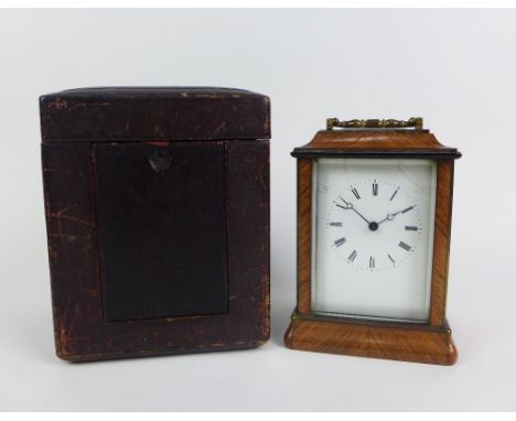 Parquetry mantle clock, with a brass handle to top, the brass movement numbered 754, with leather outer case, 16cm excluding 