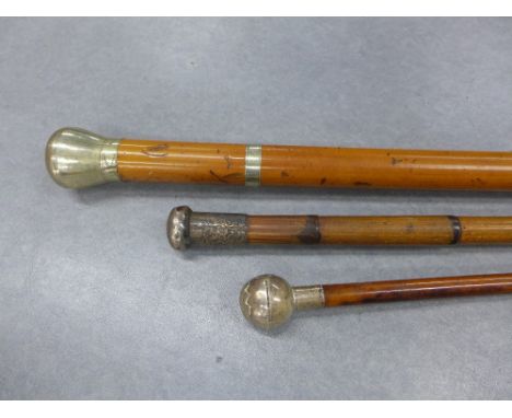 Two late 19th / early 20th century silver an white metal mounted walking canes and a Royal Scots silver mounted swagger stick