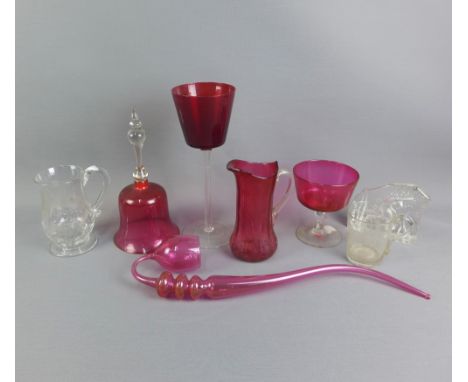 A collection of cranberry glass to include a bell, pipe and large goblet, etc, together with an etched 'Repeal' clear glass g