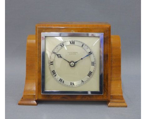 Art Deco walnut cased mantle clock, silvered dial and chapter ring with Roman numerals within square chrome frame, base numbe