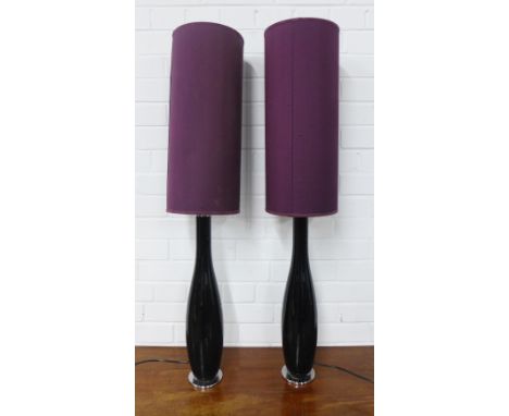 A pair of black glass table lamp bases with purple shades, 56cm high (2)