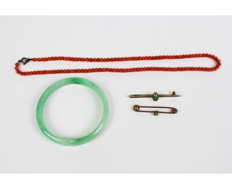 Two 9ct gold bar brooches, jade bangle and a vintage strand of coral beads (4) 