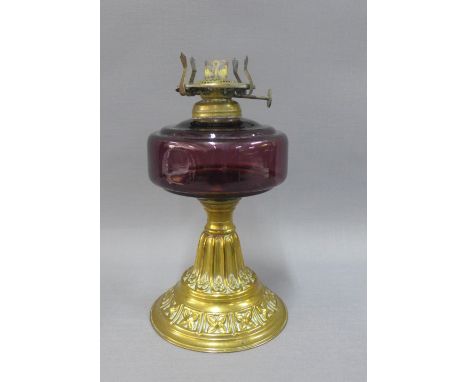Early 20th century brass oil lamp with amethyst glass well, 22cm 