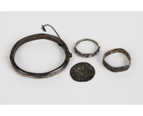 An early coin, silver baby's bangle and two silver rings, (4) 