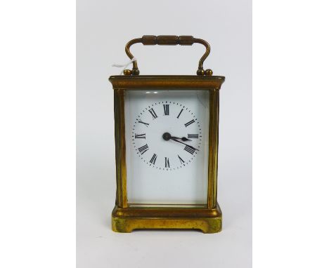 Small brass and glass panelled carriage clock, 14cm high including handle 