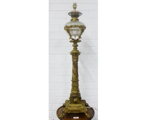 Brass oil lamp with a glass well, converted for use as an electric lamp, 80cm excluding fitting 