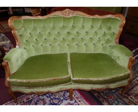 A Louis XVI style walnut sofa, with green velour upholstery, on cabriole legs, H.94 W.140 D.80cm 