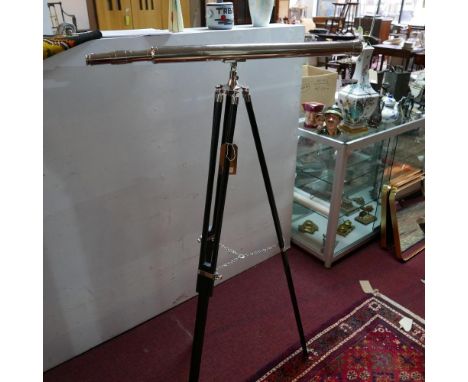 A contemporary telescope, on adjustable tripod stand 