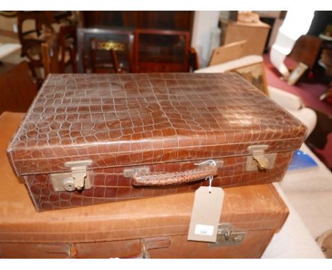 An early 20th century Army &amp; Navy crocodile skin travelling vanity case, H.16 W.56 D.35cm 