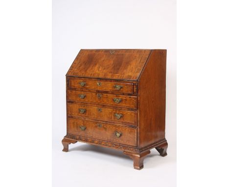 An 18th Century walnut and chequer banded bureau, the fall front opening to reveal an interior arrangement of drawers and pig
