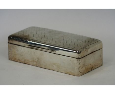 A silver cased cigarette box, three compartment wood lined interior, the lid with engine turned decoration, initialed L.M.C. 