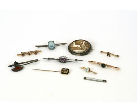 A yellow metal and enamel memorial stick pin; various 9ct gold brooches; a white metal and agate set brooch in the form of an