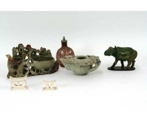 An oriental soapstone lamp; a soapstone posy holder; two bone models of Ashanti stools; a glass snuff bottle; and an oriental