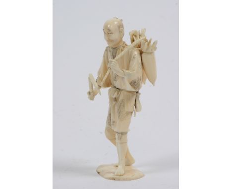 An antique carved ivory figure of stick vendor, signed to base, 18cm high 