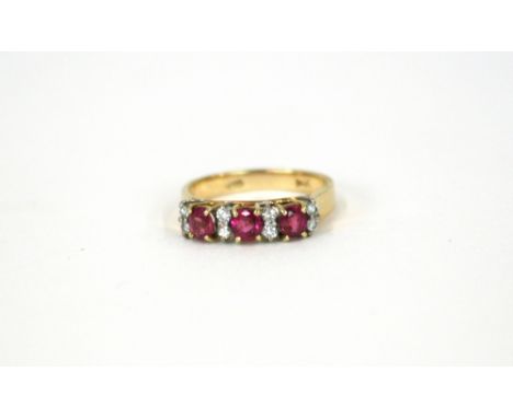 A 14ct gold diamond and ruby eleven stone ring