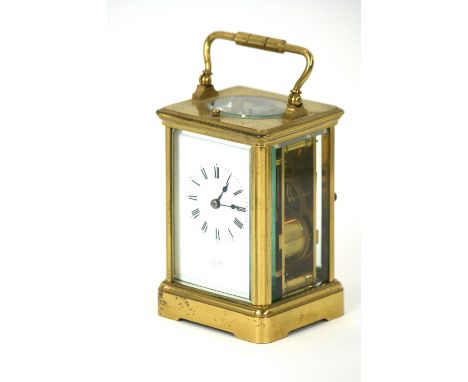 A brass cased carriage clock, with strike repeat movement, white enamel Roman numeral dial, retailed by Munsey of Cambridge, 
