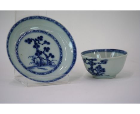 A Nankin cargo blue and white tea bowl and saucer, with tree decoration