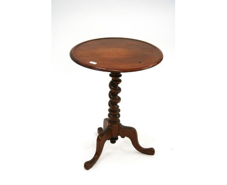 A 19th Century mahogany occasional table, having circular dished top, raised on a spiral turned column terminating in tripod 