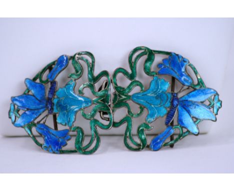 An Art Nouveau white metal and enamel belt buckle, with foliate scroll and butterfly decoration - see illustration