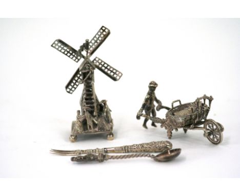 A Dutch silver model of a windmill, .833 Standard, decorated with a flag and figures, 9cm high; a continental white metal mod