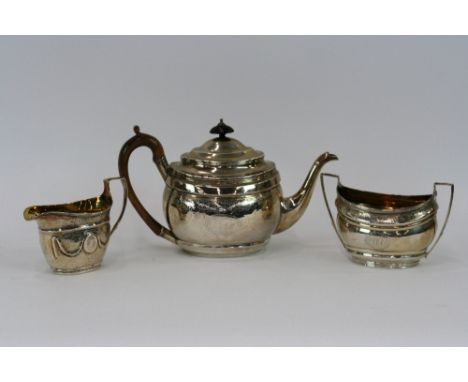A George III silver teapot, with foliate engraved decoration and monogrammed cartouche, wooden handle and lift, London 1803, 