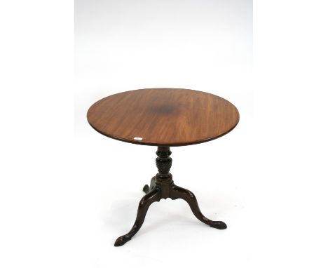 A Georgian mahogany tripod table, the circular snap top raised on a turned baluster fluted column, 84cm wide