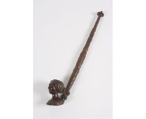 A 19th Century well carved pipe, the bowl in the form of a lady's head, 38cm long