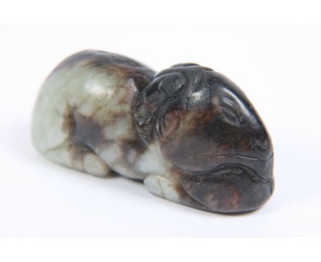 A Ming Dynasty grey and black jade carving of a recumbent lamb, 5cm long