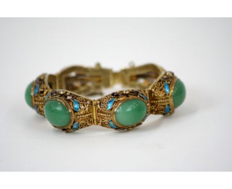 A Chinese silver gilt and enamel decorated bracelet, set four green jade cabouchon stones 