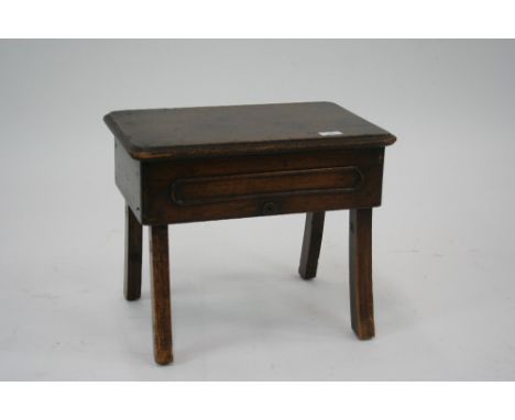 An Antique elm and mahogany stool, raised on outswept supports, 45cm wide