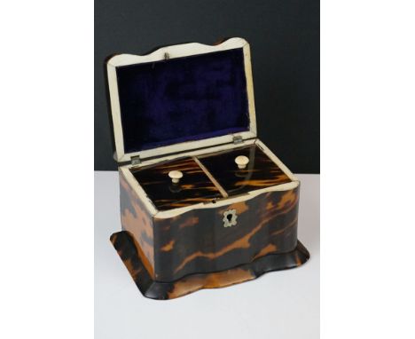 An antique 19th century tortoiseshell tea caddy with twin partition fitted interior and brass fittings. 