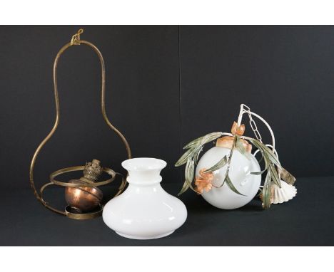 A hanging globe light fitting with flora and fauna decoration. 