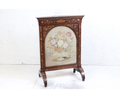 19th century Rosewood Firescreen with floral and foliate marquetry inlay, the arched glazed panel with floral display needlew