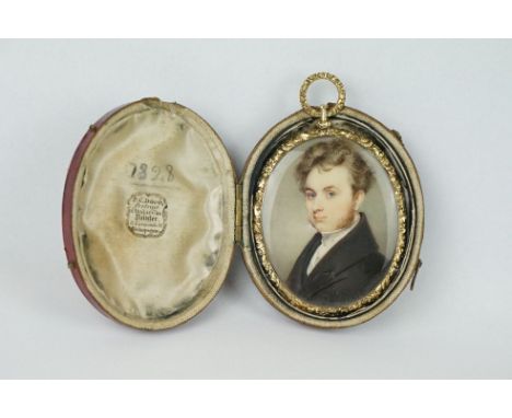 An antique 19th century miniature portrait of gentleman in traditional dress, hair mounted to reverse with seed pearl decorat